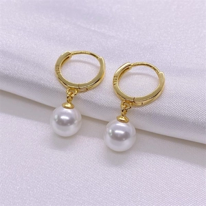 Elegant S925 sterling silver pearl drop earrings with gold hoops on white silk fabric