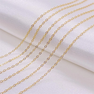 Six rows of high-polished 925 sterling silver gold-plated O-link chains on white silk