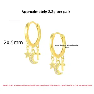 Detail view of gold S925 sterling silver hoop earrings with star moon cross charms