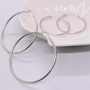 Polished S925 sterling silver hoop earrings set in two sizes on white shell plate