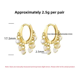 Detail view of S925 sterling silver hoop earrings with 5 clear cubic zirconia charms