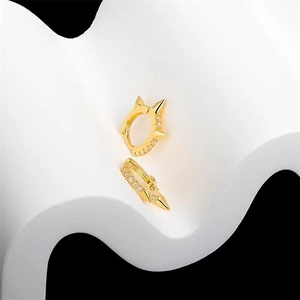 Close-up of golden S925 sterling silver hoop earrings with zircon and punk spikes