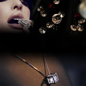 Close-up of S925 silver cube pendant necklace with a sparkling floating zircon gemstone