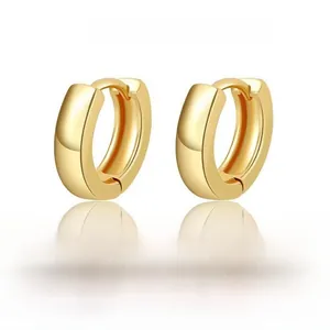 Close-up of polished 18K gold S925 silver hoop earrings with a mirror finish