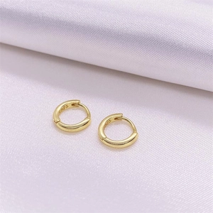 Minimalist S925 sterling silver gold hoop earrings with polished finish shown on silk