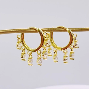 Detail view of S925 sterling silver gold plated hoop earrings with white zircon charms