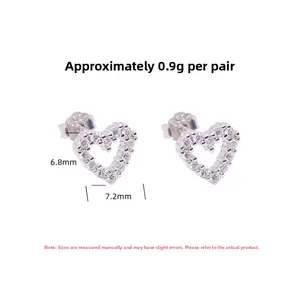 Close-up of S925 sterling silver hollow heart studs with sparkling zirconia crystals