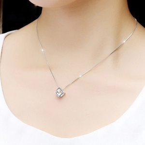 Close-up of S925 sterling silver cube pendant necklace worn on a woman neck