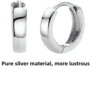 Macro detail of S925 sterling silver hoop earrings showing the hallmark and polished finish
