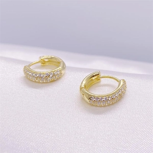 Macro shot of gold plated silver hoop earrings with two rows of cubic zirconia