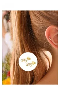 Detail showing triple star gold stud earrings in S925 silver on a model's ear