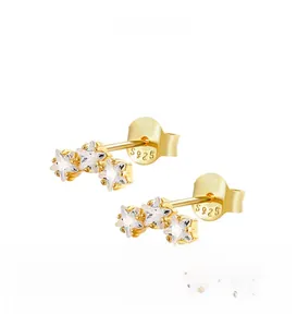 Detailed view of S925 silver triple star studs with sparkling zircon in gold finish
