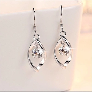 Elegant S925 sterling silver rotating zircon ear hooks hanging on a ceramic cup edge
