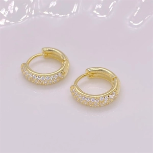 Close-up of gold plated S925 silver huggie earrings with three rows of pavé zircons