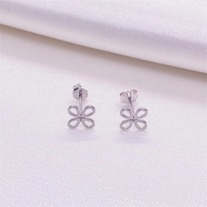 Macro shot of S925 sterling silver hollow flower stud earrings with butterfly backings