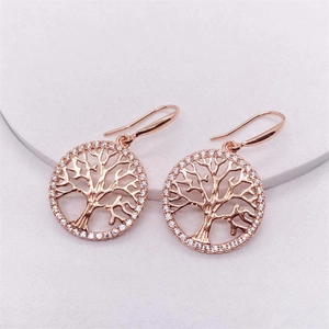 Detailed view of rose gold tree of life drop earrings with sparkling cubic zirconia crystals