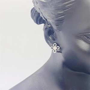 Minimalist S925 sterling silver hollow clover earrings shown on a model model bust