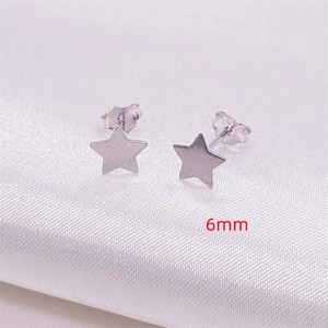 Close-up of 6mm S925 sterling silver star stud earrings on pink silk texture