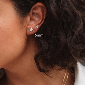 Detail shot of a 6mm S925 sterling silver star stud and a small zircon dot earring