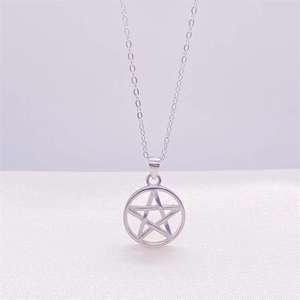 Close-up of minimalist S925 sterling silver pentagram star pendant on a fine link chain