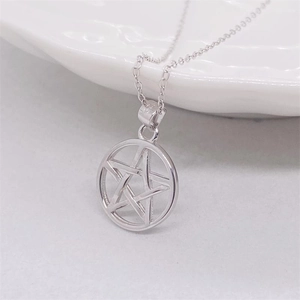 Close-up of S925 sterling silver pentagram star pendant on a delicate cross chain