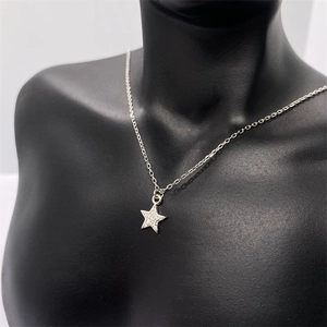 Macro shot of S925 sterling silver star pendant necklace with sparkling pavé cubic zirconia