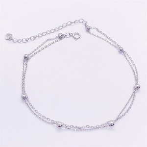 Detail of S925 sterling silver double layer chain anklet with beads and heart charm