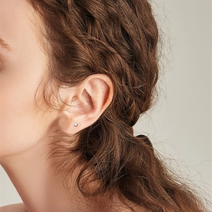Boucles d'oreilles minimalistes en argent S925 portées par un mannequin au quotidien