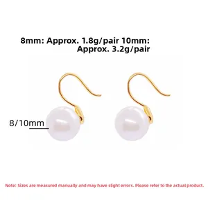 Detail view of 8mm and 10mm white round pearl drop earrings with golden hooks