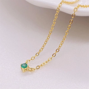 Elegant gold S925 silver necklace with a round green gemstone in a classic four-prong setting