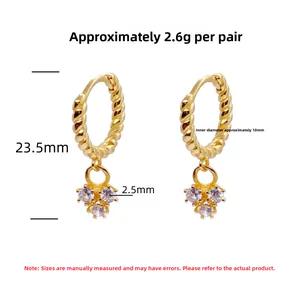 Detailed view of S925 silver gold twist hoops with three small clear zircon stones