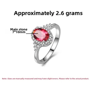 Close-up of S925 silver ring with 7x10mm oval red zircon and white side diamonds