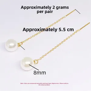 Detailed view of long tassel pearl earrings with 8mm white pearl and gold finish