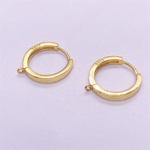 Detail of S925 sterling silver gold-plated hoop earrings with hallmark and hanging loops
