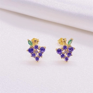 S925 silver grape earrings with purple stones and gold finish on white silk