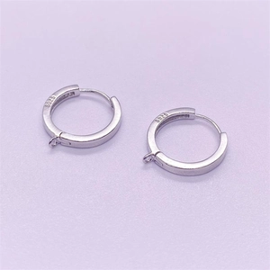Macro shot of S925 sterling silver hoop earrings with visible metal hallmark stamp