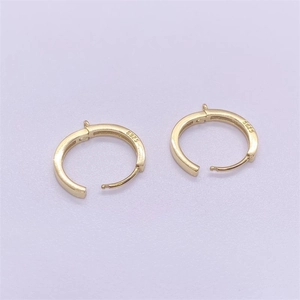 Close-up of S925 sterling silver hallmark on minimalist gold-plated hoop earrings