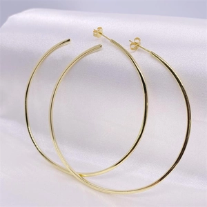 Elegant gold S925 sterling silver hoop earrings displayed on white satin fabric background