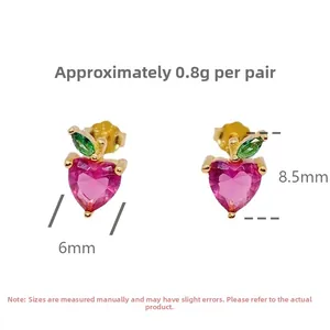Detail view of pink heart fruit earrings in S925 silver with green leaf gems, 8.5mm x 6mm