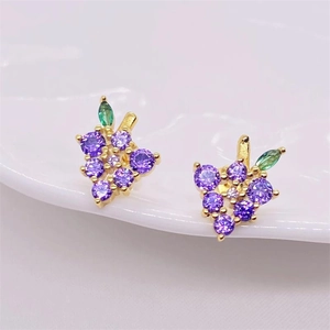 S925 silver grape stud earrings with purple crystals and green leaf on wavy surface