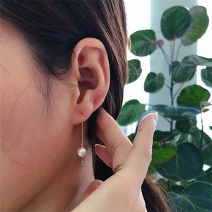 Elegant S925 silver long pearl tassel drop earring worn on a model with a gold finish