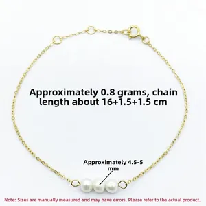 Detail view of S925 silver gold-plated bracelet with freshwater pearls and heart charm