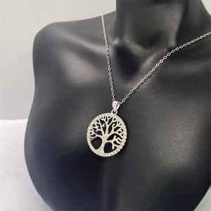 Close-up of S925 sterling silver Tree of Life pendant with white zircon on a black neck bust