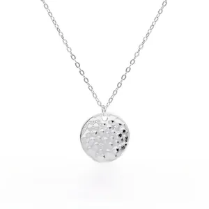 Detail of S925 sterling silver hammered circle pendant with white gold plating texture