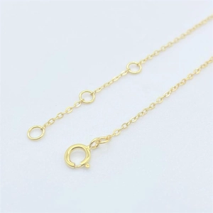 Macro view of adjustable spring ring clasp and gold chain link detail for bracelets