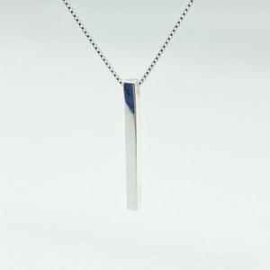 Macro detail of S925 sterling silver rectangular pillar pendant on a fine box chain