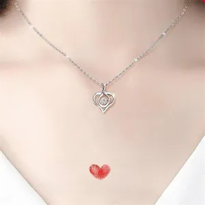 Detail of S925 sterling silver heart necklace featuring a dancing center stone on neck