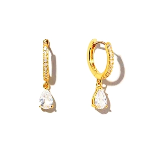 Macro shot of gold pear-shaped drop earrings featuring CZ pavé hoop and teardrop stone