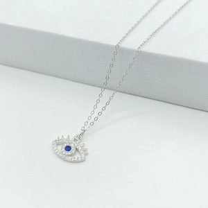 Detailed close-up of 925 sterling silver evil eye pendant with blue and white crystals