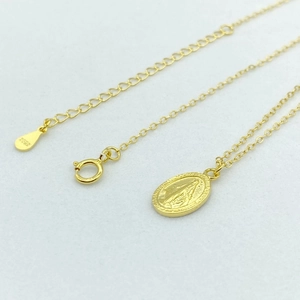 Gros plan du poinçon S925 sur le collier Vierge Marie en argent sterling plaqué or